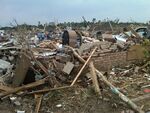 EF4 damage example -- The majority of the house, except for its foundation, is mainly destroyed. Debris is scattered throughout the destroyed house.