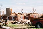 F3 damage in Hallam, Nebraska from a tornado on May 22, 2004. In the image, only the lowest level of the house remains, alongside a wall. Most of the house has been almost leveled, as indicated by the debris piled on top of the house.